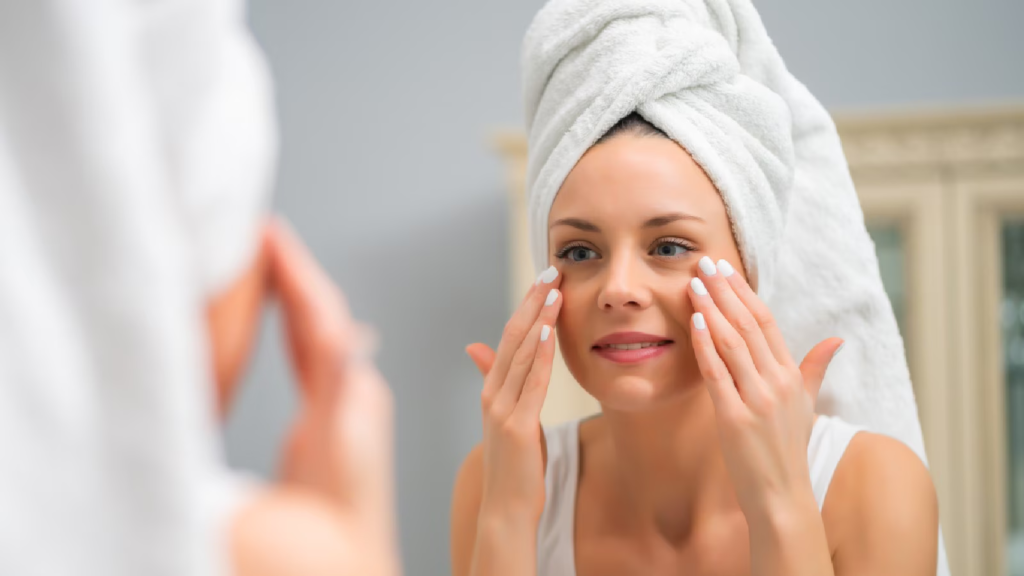 A women looking in the mirror to a freshly cleansed face